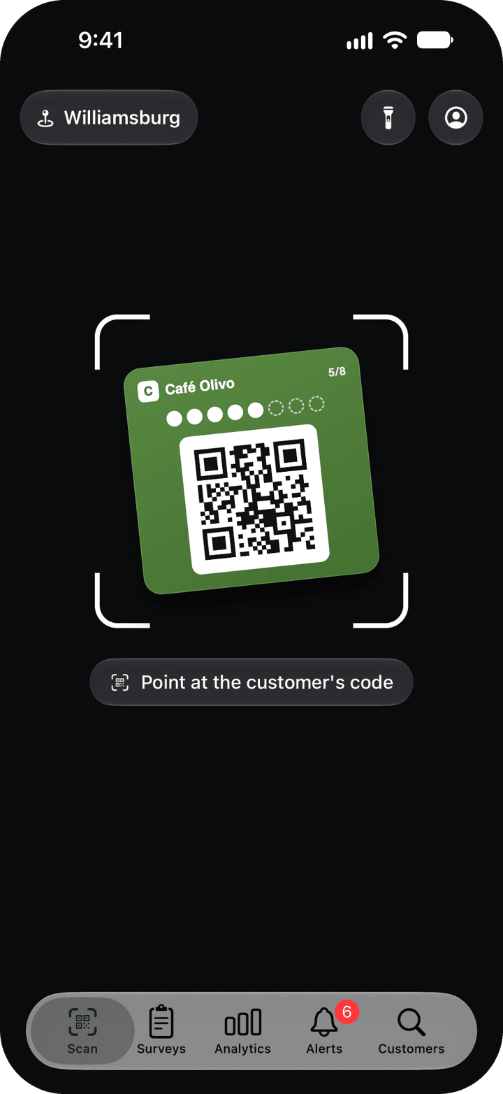 Scan tab of the staff app: the camera viewfinder with the hint "Point at the customer's code", the location and the flashlight and account buttons at the top, and the Scan, Surveys, Analytics, Alerts and Customers tabs at the bottom